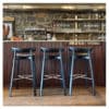 Aceray Almea-5 barstool at a bar in rustic restaurant space